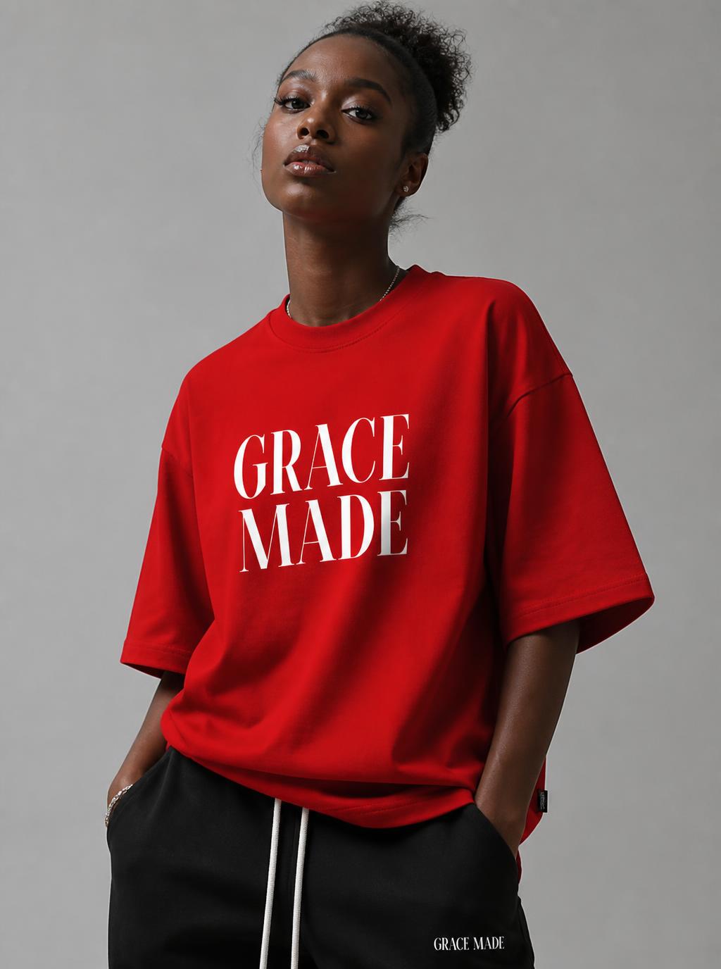 African American woman wearing a red Grace Made short-sleeve tee